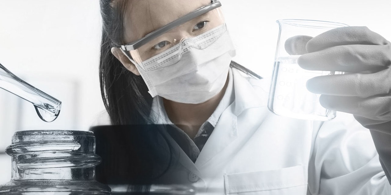 Female chemist analyzing purified water